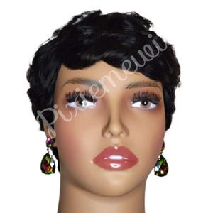 May include: A mannequin head with a short, black, curly wig. The mannequin has full lips, long eyelashes, and is wearing teardrop-shaped earrings with iridescent stones. The image has the text "Pixemeuei" in a cursive font.