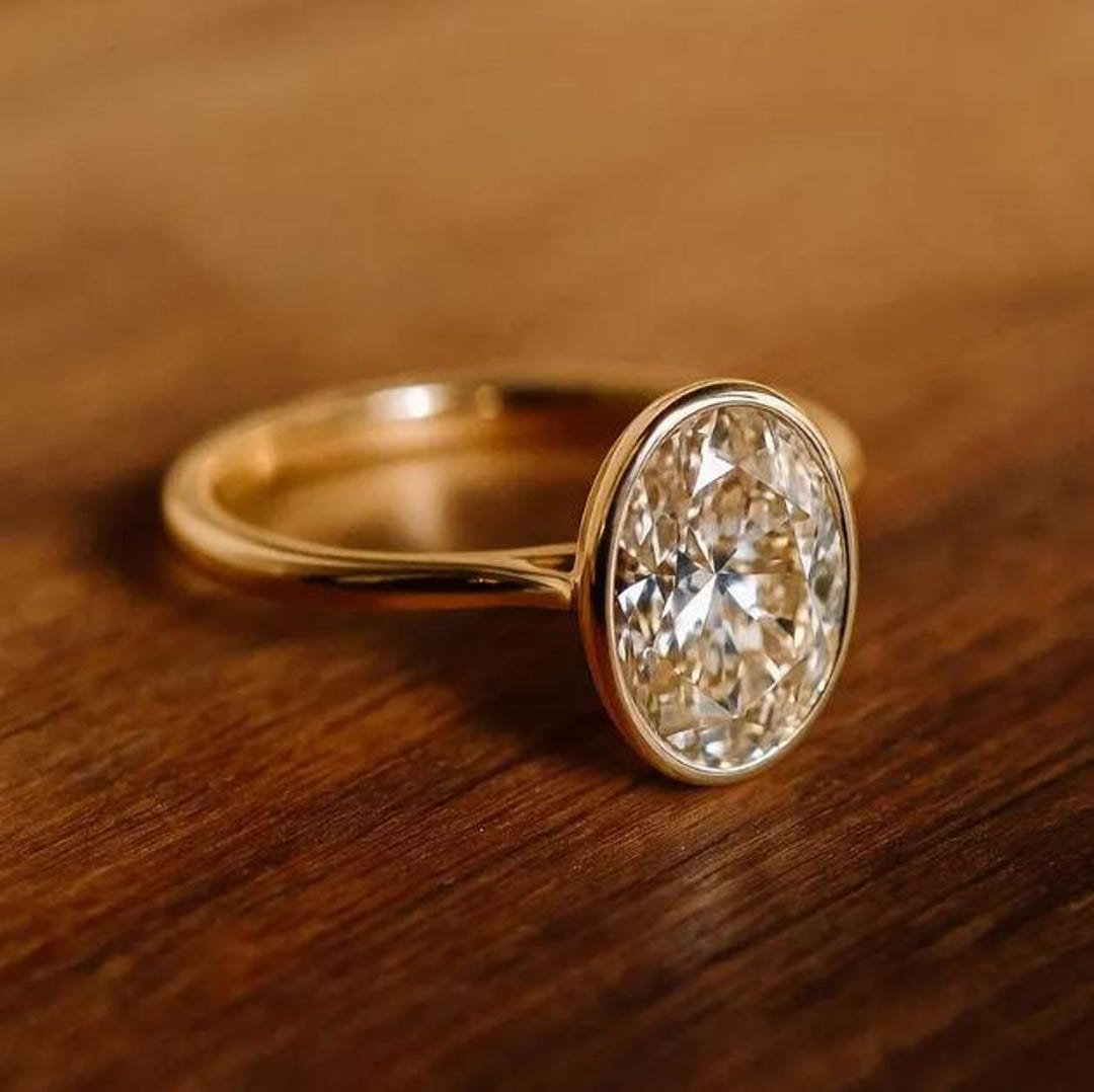 Oval Cut Moissanite Solitaire Ring – 14K Yellow Gold Bezel Engagement ...
