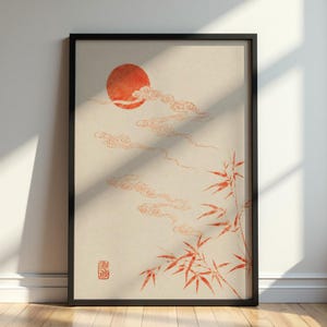 Può includere: Stampa artistica incorniciata raffigurante un paesaggio giapponese stilizzato. Un sole arancione vibrante e nuvole fluttuanti sono raffigurati sopra steli di bambù nei toni dell'arancione e del rosso su uno sfondo color crema. L'opera è incorniciata in nero.