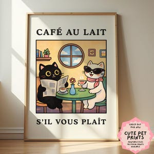 May include: A framed print featuring a cartoon scene of two cats at a cafe. One black cat reads a newspaper, while the other, a white cat wearing sunglasses, sips a drink. The text "CAFÉ AU LAIT" and "S'IL VOUS PLAÎT" are at the top and bottom.