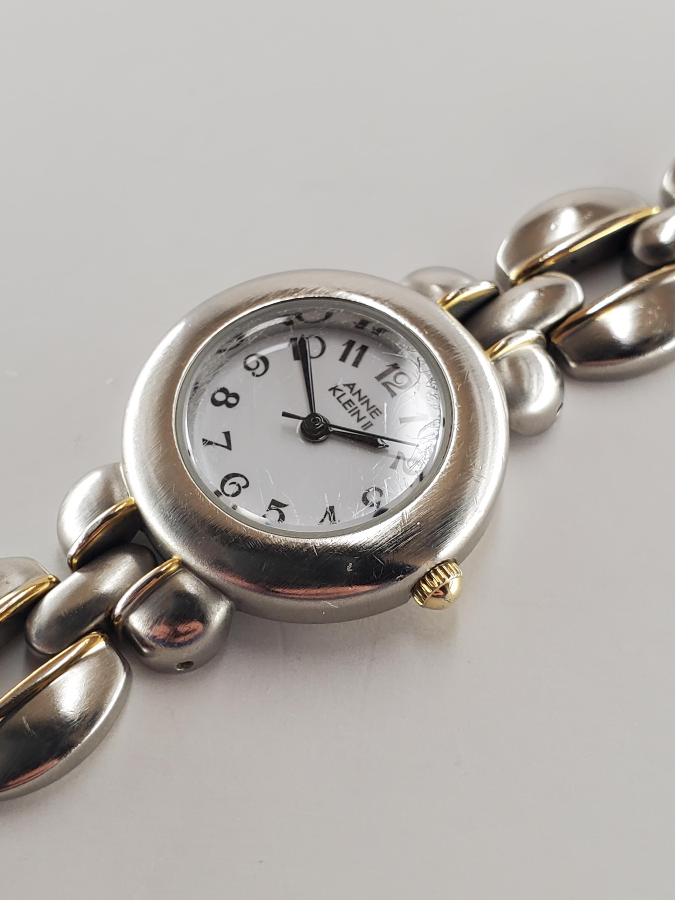 2000s Women's quartz Anne Klein II two tone watch with white dial on bracelet