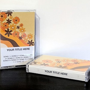 May include: Two cassette tapes with retro floral designs in orange, brown, and yellow. The text "YOUR TITLE HERE" is displayed on the label. Song titles are listed below the title. One tape is upright, and the other is lying down.