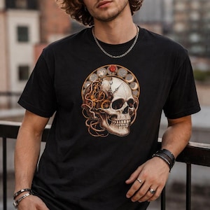 May include: Black t-shirt featuring a detailed skull design with clockwork elements and a red rose. The skull is surrounded by a circular frame with coin-like details. The design is centered on the front of the shirt.