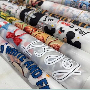 a collection of various printed materials, including wrapping paper, cards, and other decorative items, featuring a range of colorful designs and patterns.