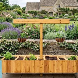 May include: A wooden raised garden bed with a light brown finish, featuring multiple planting sections. Two hanging baskets with plants are suspended from a wooden frame. The background shows a lush garden with a stone wall and a house.