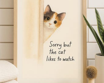 Op de afbeelding: Een ingelijste print met een aquarel illustratie van een lapjeskat die om een hoekje gluurt. De tekst "Sorry but the cat likes to watch" staat eronder. De lijst is van licht hout.