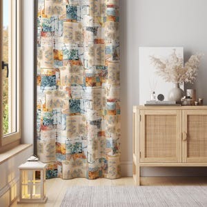May include: A patterned curtain with a patchwork design in beige, blue, orange, and white. The curtain features a repeating pattern of squares with leaf and floral motifs. A wooden cabinet and a decorative lantern are in the background.