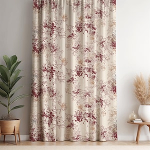 May include: Cream-coloured curtain with a repeating floral pattern in burgundy and tan. The design features stylized flowers and leaves with a watercolour-like effect, creating a soft, artistic look. The curtain is hanging in front of a white wall.