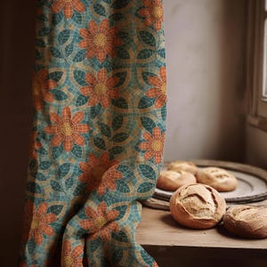 May include: A patterned fabric curtain with a floral mosaic design in shades of orange, teal, and yellow. The curtain is draped next to a wooden surface with several round loaves of bread.
