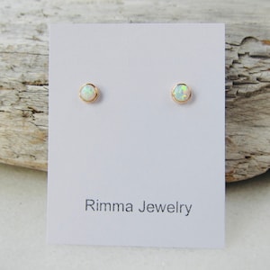 Opal stud earrings, solid gold studs, tiny studs, 14k opal earrings, birthstone earrings, man made opals. Sale.