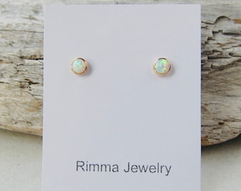 Opal stud earrings, solid gold studs, tiny studs, 14k opal earrings, birthstone earrings, man made opals. Sale.