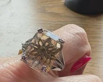 stunning silver and gold filigree design, perfect for adding a touch of elegance to any outfit. Item 579