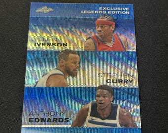 May include: A collectible trading card featuring Allen Iverson, Stephen Curry, and Anthony Edwards. The card has a blue holographic background with the text "EXCLUSIVE LEGENDS EDITION". The players are shown in their basketball uniforms.