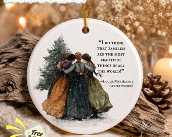 May include: A round white ceramic ornament featuring a watercolor illustration of four figures in long dresses standing together near a pine tree. The text reads: I DO THINK THAT FAMILIES ARE THE MOST BEAUTIFUL THINGS IN ALL THE WORLD! -Louisa May Alcott