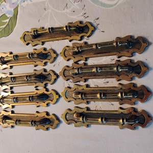 Vintage bronze metal cupboard or drawer pulls.