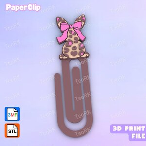 Op de afbeelding: Een bruine paperclip met een decoratieve topper in de vorm van een konijnensilhouet met een luipaardprint en een felroze strik. De afbeelding bevat tekstlabels met PaperClip, 3MF, STL en 3D PRINT FILE op een lichte achtergrond.