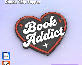 May include: A heart-shaped badge reel topper with the words "Book Addict" in white, outlined in black, and set against a gray background. The heart has a red border and star accents. The text "Badge Reel Topper / Phone Grip Topper" is at the top.