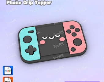 May include: A badge reel or phone grip topper shaped like a handheld gaming console. The device features a light blue left controller, a pink right controller, and a black center screen with a white smiling face and pink cheeks. Text reads Badge Reel Topper / Phone Grip Topper and 3D Print File.