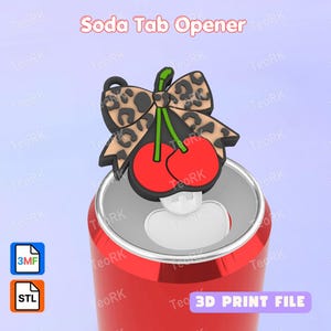 May include: A red soda can with a cherry-themed bottle opener. The opener features two red cherries, a green stem, and a bow with a leopard print design. The text "Soda Tab Opener" is at the top.