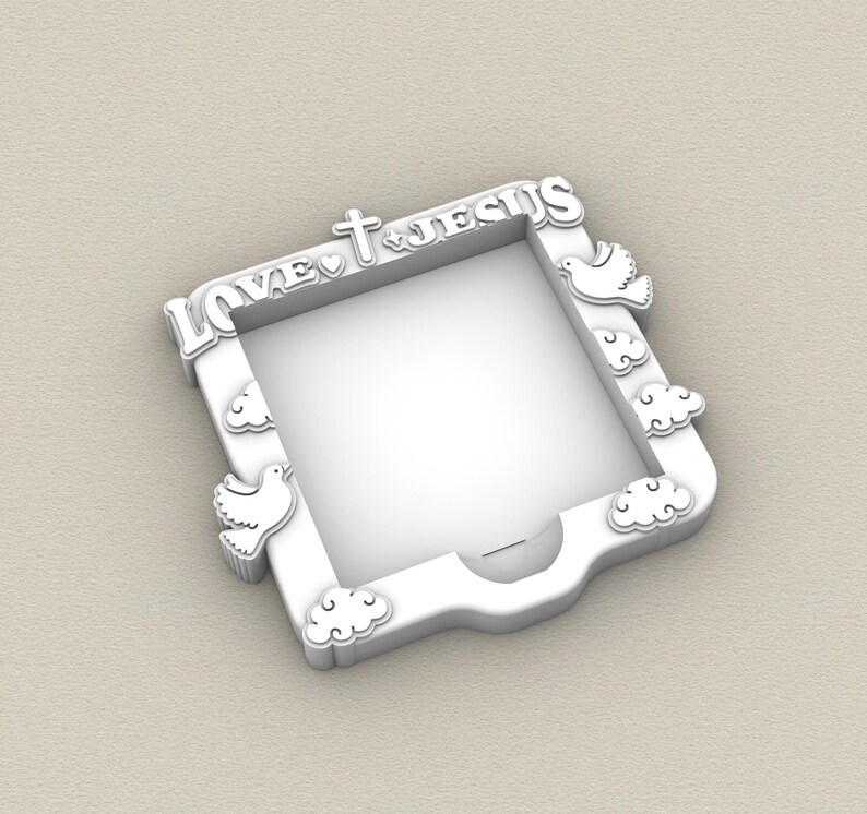 May include: White picture frame with the words "LOVE JESUS" in a decorative font. The frame features a cross, heart, doves, and cloud accents. The frame is square with a rounded bottom edge.