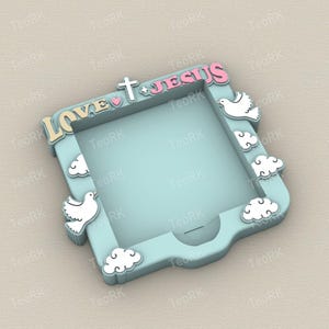 May include: A light blue decorative frame with the words "LOVE JESUS" in a playful font. The frame is adorned with white doves, clouds, a cross, and a heart. The frame is designed with a square opening.