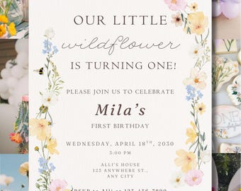 May include: A birthday invitation with a floral design. The invitation reads "Our Little Wildflower is Turning One!" and includes the date, time, and location of the party. The invitation is decorated with watercolour flowers in pastel shades.