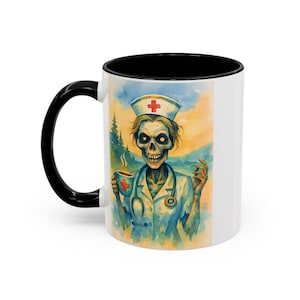 May include: White ceramic coffee mug with a black handle and interior. The mug features a watercolor illustration of a zombie nurse holding a cup of coffee. The nurse is wearing a blue uniform and a nurse's cap with a red cross.
