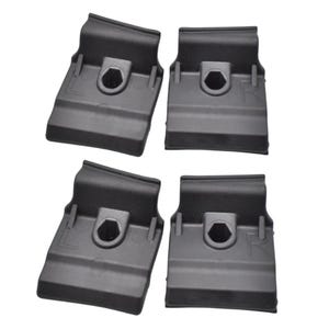 May include: Four black plastic roof rack clips. Each clip has a hexagonal hole in the center and a rectangular shape. The clips are designed to attach to a vehicle's roof rails.