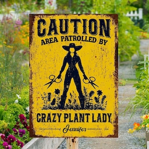 May include: A rectangular yellow metal sign with a distressed finish. The sign reads "CAUTION AREA PATROLLED BY CRAZY PLANT LADY" in black text. A silhouette of a person holding scissors is in the center. The name "Jennifer" is at the bottom.
