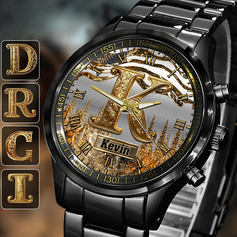 May include: Black wristwatch with a gold-colored face featuring the letter "K" and the name "Kevin". The watch has gold hands and Roman numeral hour markers. The watchband is black.