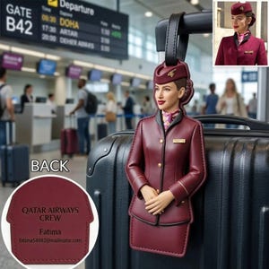 May include: A burgundy-coloured luggage tag in the shape of a Qatar Airways flight attendant, wearing a matching hat and uniform. The tag is attached to a black suitcase. The back of the tag has the text "QATAR AIRWAYS CREW" and the name "Fatima".