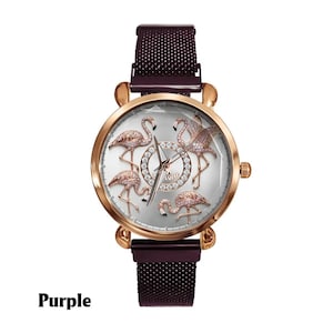 May include: A rose gold watch with a purple mesh band. The watch face features five bejeweled flamingo figures on a silver background. The word "Purple" is printed in black at the bottom of the image.