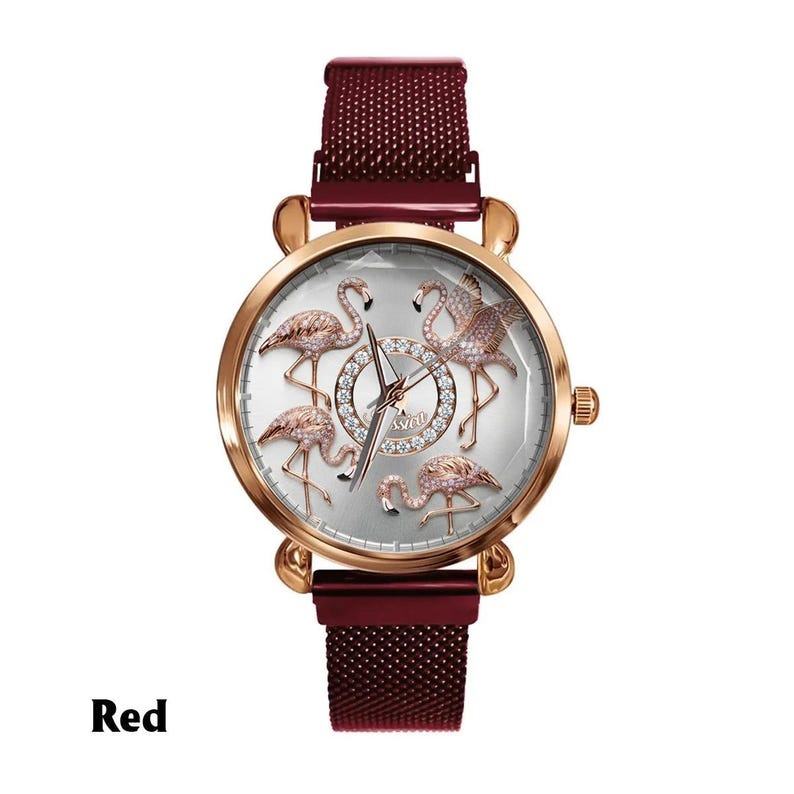 May include: A rose gold watch with a red mesh band. The watch face features five flamingo designs with crystal accents. The watch hands are silver. The word "Swat" is written in the center of the watch face. The word "Red" is written at the bottom of the image.