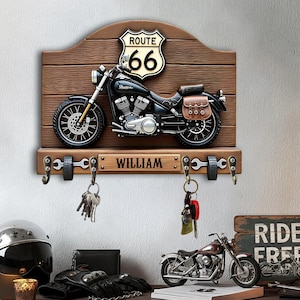 May include: A Route 66 themed key holder featuring a black motorcycle model on a wooden plaque. The plaque has a Route 66 sign and a nameplate reading "WILLIAM". Includes key hooks and decorative elements.