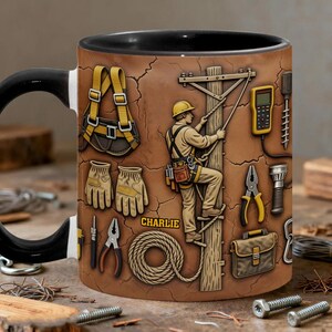 May include: A brown ceramic mug featuring a detailed illustration of an electrician climbing a utility pole. The design includes tools, a harness, gloves, and the name "Charlie". The mug has a black handle and rim.