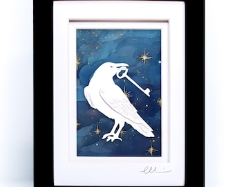 May include: A framed artwork featuring a white silhouette of a raven holding a key in its beak against a dark blue, cloud-like background with gold star accents. The piece is encased in a black frame with a white mat and includes a signature.