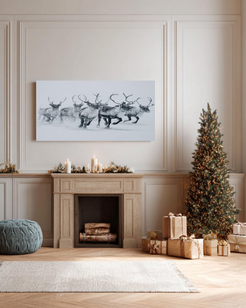 May include: A grayscale canvas print shows a herd of reindeer running across a snowy scene. The artwork hangs above a fireplace decorated for the festive season, with a Christmas tree and wrapped gifts. The reindeer are depicted in shades of grey and white.