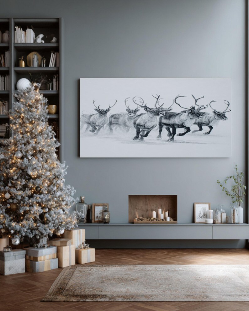 May include: A monochrome painting of reindeer in motion adorns a wall above a fireplace. A decorated Christmas tree with lights and baubles stands to the left, with wrapped presents beneath. The room has a modern, minimalist design with a grey colour scheme.