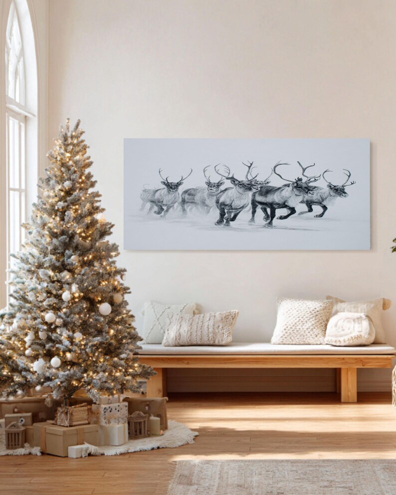 May include: A monochrome artwork shows reindeer running in snow. A decorated Christmas tree with lights and white baubles is on the left. A wooden bench with cushions is in front of the artwork, creating a festive scene.