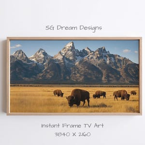 May include: A framed landscape print featuring a herd of bison grazing in a golden field, with snow-capped mountains in the background. The sky is a clear blue. The print is labeled "Instant Frame TV Art" and has a resolution of 3840 x 2160.