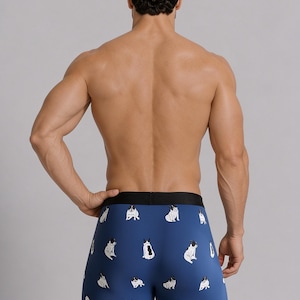 May include: Blue boxer briefs featuring a repeating pattern of small white and black French Bulldog illustrations. The garment has a solid black elastic waistband and a fitted silhouette, showcasing the dogs in various sitting and standing poses.