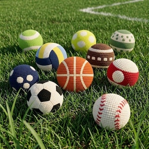 May include: A selection of handmade crochet sports balls, including a basketball, baseball, football, volleyball, and others. The balls are in various colours and patterns, set on a green grassy field.