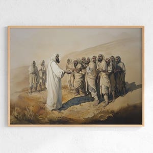 May include: Watercolor painting in a wooden frame depicting a religious scene. A figure in white robes gestures towards a group of people in similar attire. The background features a desert landscape with muted tones of brown and beige.