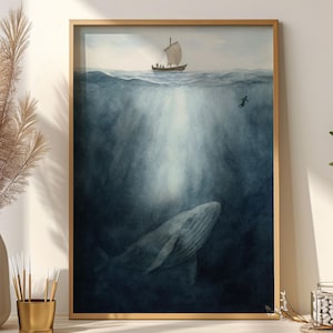 以下が含まれることがあります： 水中で泳ぐクジラと、水面にヨットが描かれた額入りの水彩画プリント。ダイバーも確認できます。このアートワークは主に青と白で、上から光線が差し込んでいます。