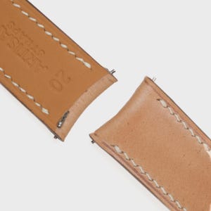 May include: A set of three ceramic mugs with a speckled, matte finish. The mugs are in shades of cream, gray, and black. Each mug has a simple, modern design, perfect for coffee or tea. The mugs are stacked on top of each other.