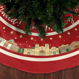 May include: A red Christmas tree skirt with a white border and a festive design. The skirt features a repeating pattern of buildings, trees, and stars, with the words "Merry Christmas" in white script. The skirt is made of a soft fabric.