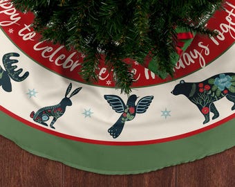 May include: A Christmas tree skirt with a cream background, red border, and green trim. The skirt features illustrations of a rabbit, bird, and bear, with floral accents. The text "Happy to celebrate holidays together" is printed on the red border.