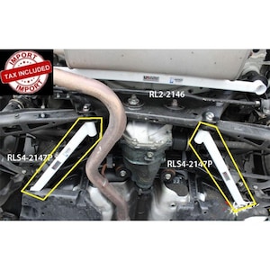 May include: Two white automotive chassis reinforcement bars labeled RLS4-2147P installed on a vehicle undercarriage, alongside a white rear lower bar labeled RL2-2146. The components are positioned near the differential and exhaust system.