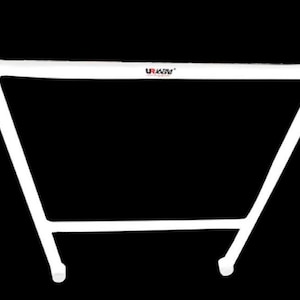 May include: A white automotive chassis reinforcement bar featuring a trapezoidal frame design with tubular metal construction. The top horizontal bar displays the black and red text logo UR Racing. The structure includes circular mounting points at each corner.
