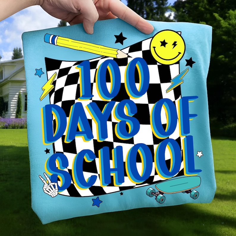 May include: A light blue pillow with the text "100 DAYS OF SCHOOL" in blue and yellow. The design includes a checkered flag, a yellow pencil, a smiley face, lightning bolts, stars, a peace sign, and a skateboard.
